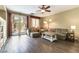 Bright living room featuring wood-look floors, comfortable seating, and backyard access at 922 Lloyd George Dr, Henderson, NV 89052
