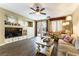Cozy living room with built-in shelving, ceiling fan, and sliding glass doors to the backyard at 922 Lloyd George Dr, Henderson, NV 89052