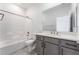 Bathroom with a shower-tub combination, a white sink and vanity, and neutral wall color at 9314 Observatory St, Las Vegas, NV 89143