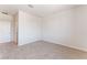 Well-lit carpeted bedroom with neutral paint and an entry door at 9314 Observatory St, Las Vegas, NV 89143