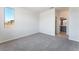Carpeted bedroom showing a bathroom entrance and a large window view at 9314 Observatory St, Las Vegas, NV 89143