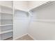Walk-in closet featuring built-in shelving, providing ample storage, and a carpeted floor at 9314 Observatory St, Las Vegas, NV 89143