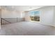 Bright loft area featuring neutral decor, plush carpeting, and a sliding glass door to a private balcony at 9314 Observatory St, Las Vegas, NV 89143