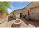 Inviting backyard with a fire pit, patio, and outdoor dining area perfect for entertaining at 9393 New Utrecht St, Las Vegas, NV 89178
