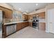 Eat-in kitchen with stainless steel appliances and natural-stained wood cabinets at 9393 New Utrecht St, Las Vegas, NV 89178