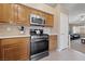 Eat-in kitchen featuring stainless steel appliances and access to the living room at 9393 New Utrecht St, Las Vegas, NV 89178