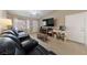 Spacious living room with seating and a convenient desk and entertainment center at 9393 New Utrecht St, Las Vegas, NV 89178