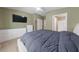 Main bedroom with a spacious bed, large dressers, a TV, and access to the bathroom at 9393 New Utrecht St, Las Vegas, NV 89178
