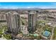 Aerial view showcasing the buildings, tennis court, pool, and lush landscaping at 1 Hughes Center Dr # 1901, Las Vegas, NV 89169