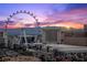 Dramatic skyline view of Las Vegas featuring The High Roller with colorful sunset hues at 1 Hughes Center Dr # 1901, Las Vegas, NV 89169