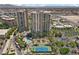 Panoramic aerial shot showcasing the buildings with palm trees, tennis court, and sparkling pool at 1 Hughes Center Dr # 1901, Las Vegas, NV 89169