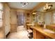 Luxurious bathroom with double vanity, a large mirror, and tiled floors at 1 Hughes Center Dr # 1901, Las Vegas, NV 89169