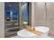 Modern bathroom features freestanding tub and expansive views of the city skyline, creating a relaxing oasis at 1 Hughes Center Dr # 1901, Las Vegas, NV 89169