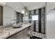 Sleek bathroom features stone counters, unique fixtures and a glass enclosed shower at 1 Hughes Center Dr # 1901, Las Vegas, NV 89169