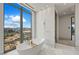 Contemporary bathroom featuring a freestanding tub, marble flooring, and a stunning view of the High Roller at 1 Hughes Center Dr # 1901, Las Vegas, NV 89169