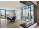 Elegant dining area with city views, a modern fireplace, and seating for eight at 1 Hughes Center Dr # 1901, Las Vegas, NV 89169
