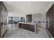 Modern kitchen featuring a large island with a stone countertop, stainless steel appliances, and a view of the city at 1 Hughes Center Dr # 1901, Las Vegas, NV 89169