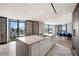 Bright kitchen featuring a large island with a stone countertop, a modern design, and incredible city views at 1 Hughes Center Dr # 1901, Las Vegas, NV 89169