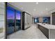 Spacious kitchen offering an island featuring stone countertops, abundant lighting, and impressive nighttime city views at 1 Hughes Center Dr # 1901, Las Vegas, NV 89169