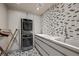 Modern laundry room with a stackable washer/dryer, and stylish patterned floors at 1 Hughes Center Dr # 1901, Las Vegas, NV 89169