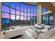 Bright living room featuring floor to ceiling windows with spectacular city views and stylish white sofas at 1 Hughes Center Dr # 1901, Las Vegas, NV 89169