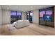 Bright living room showcasing large windows, light hardwood floors, and a comfortable sofa with city views at 1 Hughes Center Dr # 1901, Las Vegas, NV 89169