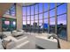Inviting living area featuring floor-to-ceiling windows with city views and contemporary white sofas at 1 Hughes Center Dr # 1901, Las Vegas, NV 89169