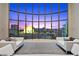 Bright living room featuring floor to ceiling windows with spectacular city views and stylish white sofas at 1 Hughes Center Dr # 1901, Las Vegas, NV 89169