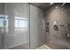 Modern shower with floor-to-ceiling marble, a rainfall showerhead, and a glass partition at 1 Hughes Center Dr # 1901, Las Vegas, NV 89169