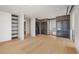 Large walk-in closet with wood floors, custom shelving, and enclosed display cabinets at 1 Hughes Center Dr # 1901, Las Vegas, NV 89169