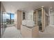 Bright walk-in closet featuring custom storage, mirrored doors, and a central display island at 1 Hughes Center Dr # 1901, Las Vegas, NV 89169