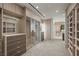 Expansive walk-in closet with elegant wood finishes, ample shelving, and drawer space at 1 Hughes Center Dr # 1901, Las Vegas, NV 89169