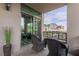 Balcony with chairs and cityscape views through the sliding glass door at 1 Hughes Center Dr # 308, Las Vegas, NV 89169