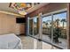 Bedroom with a private balcony with city views, palm trees, and comfortable exercise equipment at 1 Hughes Center Dr # 308, Las Vegas, NV 89169