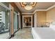 Comfortable bedroom shows access to office area and private balcony with views of the city at 1 Hughes Center Dr # 308, Las Vegas, NV 89169