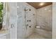 Detailed view of the tiled shower with a bench and sleek fixtures at 1 Hughes Center Dr # 308, Las Vegas, NV 89169
