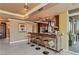 Modern wet bar featuring granite counters, stainless steel appliances, and seating for entertaining at 1 Hughes Center Dr # 308, Las Vegas, NV 89169