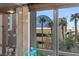 A window view overlooking the cityscape with tall palm trees at 1 Hughes Center Dr # 308, Las Vegas, NV 89169