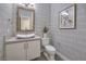 Stylish powder room features designer wallpaper, a vessel sink, and modern fixtures at 10 Sugarberry Ln, Las Vegas, NV 89135