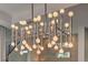 Close up of the modern chandelier hanging over the dining area in the main living area at 10 Sugarberry Ln, Las Vegas, NV 89135