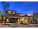 Beautifully landscaped home exterior with a modern design, stylish stone accents, and a glass garage door at 10 Sugarberry Ln, Las Vegas, NV 89135