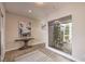 Bright foyer with modern art, stylish decor, and a view of the landscaped outdoor courtyard at 10 Sugarberry Ln, Las Vegas, NV 89135