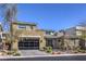 Contemporary two-story home showcasing a modern design, integrated garage, and well-maintained landscaping at 10 Sugarberry Ln, Las Vegas, NV 89135