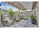 Relaxing backyard patio area with covered pergola and comfortable seating at 10484 Rose Park Ave, Las Vegas, NV 89135