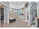 Luxurious bathroom features a walk-in shower, soaking tub, dual sinks, and modern fixtures at 10484 Rose Park Ave, Las Vegas, NV 89135