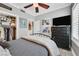 Comfortable bedroom featuring neutral colors, a ceiling fan, and a closet at 10484 Rose Park Ave, Las Vegas, NV 89135