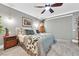 Cozy bedroom with wood-look floors, neutral walls, and king size bed at 10484 Rose Park Ave, Las Vegas, NV 89135