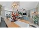 Elegant dining area showcasing a modern chandelier and open-concept living space at 10484 Rose Park Ave, Las Vegas, NV 89135