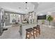 Well-lit kitchen featuring a granite countertop island with seating and ample storage at 10484 Rose Park Ave, Las Vegas, NV 89135