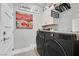Laundry room featuring modern appliances and a fun art print at 10484 Rose Park Ave, Las Vegas, NV 89135